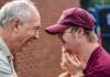 A young man with Downs Syndrome celebrates with his father