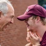 A young man with Downs Syndrome celebrates with his father