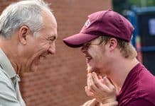 A young man with Downs Syndrome celebrates with his father