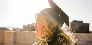 woman wearing academic regalia during daytime