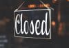 A black sign saying 'Closed' in curly handwriting.