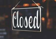 A black sign saying 'Closed' in curly handwriting.