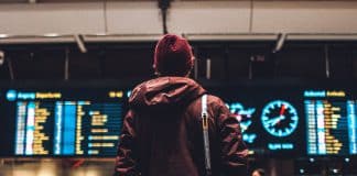 person looking up to the flight schedules