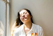 woman standing near window during daytime
