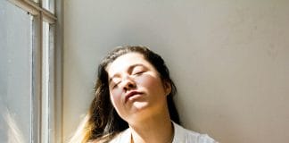 woman standing near window during daytime