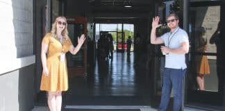 two man and woman standing on doorway