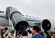 people walking towards airplane during daytime