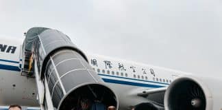 people walking towards airplane during daytime