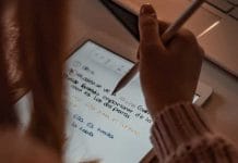 person writing on white paper