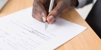 person writing on white paper