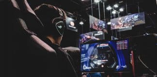 person sitting on gaming chair while playing video game