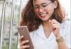 woman in white button up shirt holding silver iphone 6