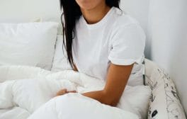 woman sitting on bed
