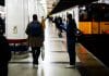 man standing on train terminal
