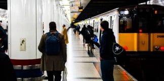 man standing on train terminal