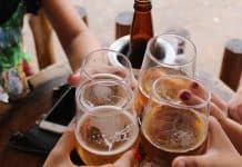 four clear stemless glasses