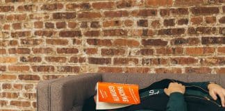 person sleeping on sofa near the wall