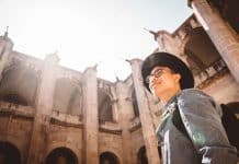 man smiling while looking at the building
