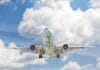 gray and white airplane on flight near clear blue sky