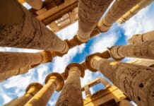 low angle photography of brown concrete building under blue sky during daytime