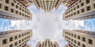 low angle photography of two white concrete buildings