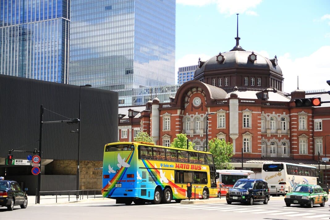 blue bus on road near building during daytime