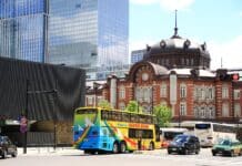 blue bus on road near building during daytime