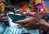 shallow focus photo of person holding black Android smartphone