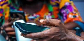 shallow focus photo of person holding black Android smartphone