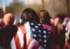 woman with US American flag on her shoulders