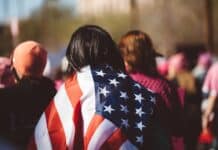 woman with US American flag on her shoulders