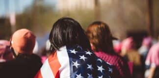 woman with US American flag on her shoulders