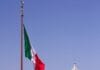 white concrete building with flag of us a during daytime