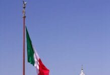 white concrete building with flag of us a during daytime