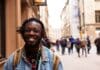 selective focus of man smiling near building