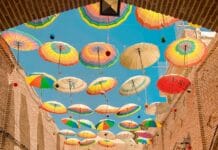 assorted-colored umbrellas hanging on alley