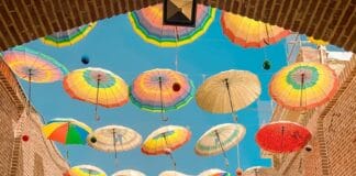 assorted-colored umbrellas hanging on alley