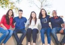 group of people sitting on bench near trees duting daytime