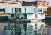 white wooden house near body of water at daytime