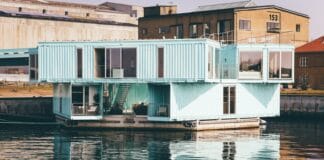 white wooden house near body of water at daytime