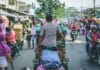 selective photography of man pedaling wagon