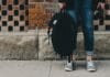 person standing near brown concrete wall