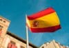 a spanish flag flying in front of a building