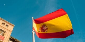 a spanish flag flying in front of a building