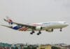A large jetliner flying through a cloudy sky