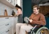 A man in a wheel chair in a kitchen