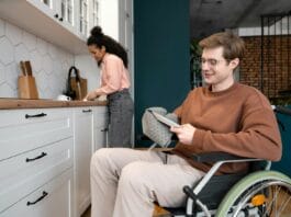 A man in a wheel chair in a kitchen