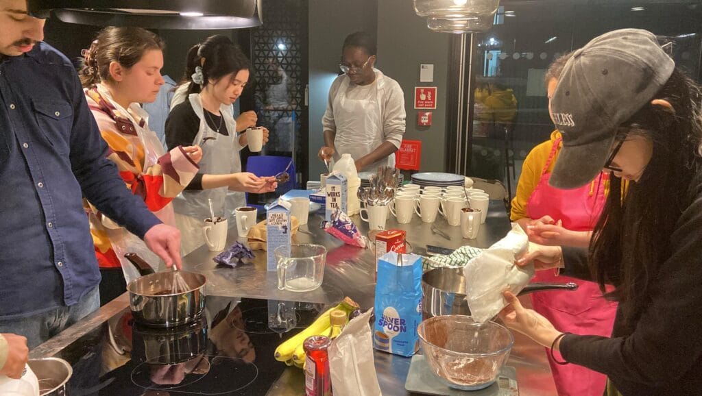 Photo of students making waffles in  the Galley Kitchen of Purdown View Student Accommodation at UWE Bristol
