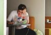 man wearing white top using MacBook